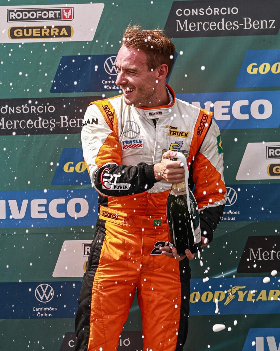 Victor Franzoni celebrating on the podium at a Copa Truck race